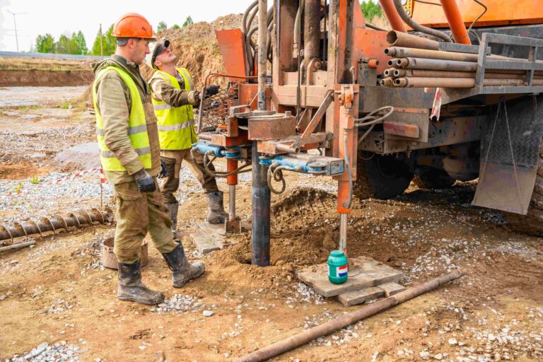 Structural engineers in Montreal carrying out a soil test and foundation inspection on a residential construction site.